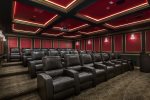 The theater offers luxurious leather seating, a podium with microphone and stage